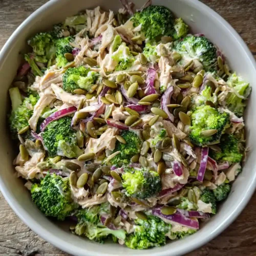 loaded chicken and broccoli salad in white ceramic bowl